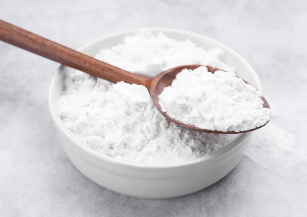 Glucose syrup powder in bowl with wooden spoon
